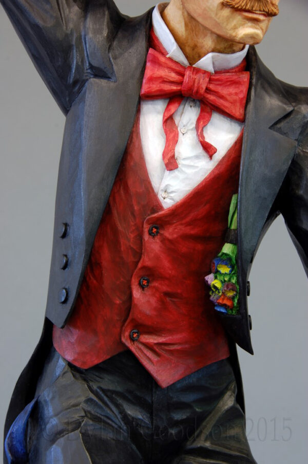 The flower bouquet hanging inside the lapel of the magician's coat is just one of the details that Dylan Goodson incorporated into this carving.