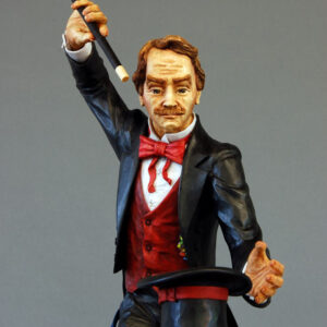 Standing with arm and wand up raised, the Magician stares into his empty hat sitting before him.