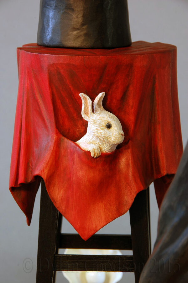 The rabbit tucked in the secret pocket of the table cloth on Dylan Goodson's wood carving, "The Magician".