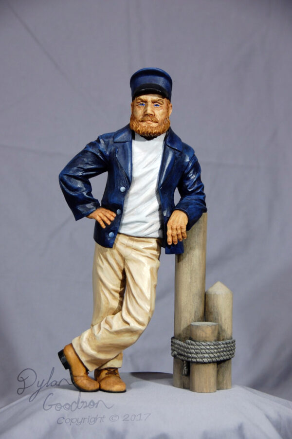Dylan's woodcarving of a Sea Captain leaning against a dock post