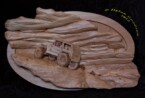 pictorial relief scene of a rock climbing jeep with mountains and clouds in the background