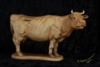 Cow standing looking to the right carved by dylan goodson
