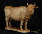 Cow standing looking to the right carved by dylan goodson