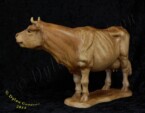 Cow standing looking to the right carved by dylan goodson