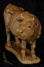 Cow standing looking to the right carved by dylan goodson