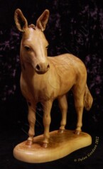 Donkey standing with his head turned to the side carved by dylan goodson
