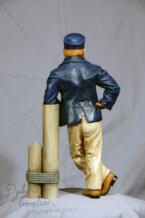Dylan's woodcarving of a Sea Captain leaning against a dock post
