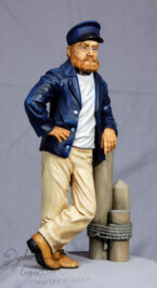 Dylan's woodcarving of a Sea Captain leaning against a dock post