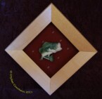 relief carving of a bass mounted in a shadow box frame