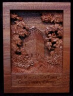 pictorial relief scene of the Flagg mountain fire lookout tower in coosa county alabama carved from mahogany