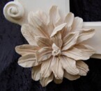 close up of one of the flowers on the corners of the ornate frame