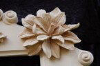 close up of one of the flowers on the corners of the ornate frame