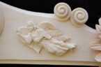 close up of one of the angels on the ornate frame