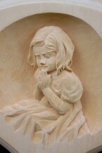 close of one of the relief carvings on the ornate frame