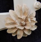 close up of one of the flowers on the corners of the ornate frame