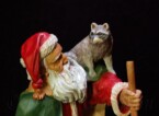 Santa Claus looking at the raccoon on his shoulder carved by dylan goodson