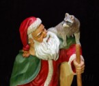 Santa Claus looking at the raccoon on his shoulder carved by dylan goodson