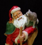 Santa Claus looking at the raccoon on his shoulder carved by dylan goodson