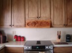 Dylan Goodson's pictorial relief scene stove hood installed in the kitchen
