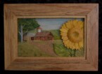 pictorial relief scene of a country landscape with a sunflower in the foreground and a barn in the background