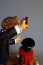 A look down into the empty hat over the shoulder of the Magician.